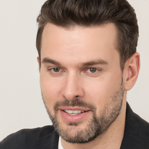 Joyful white adult male with short  brown hair and brown eyes