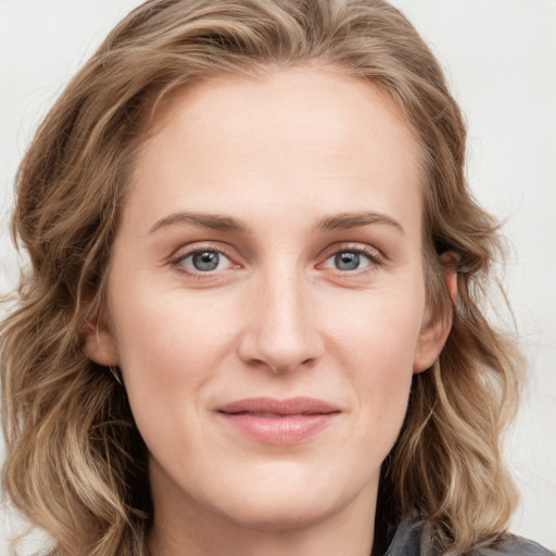 Joyful white young-adult female with long  brown hair and blue eyes