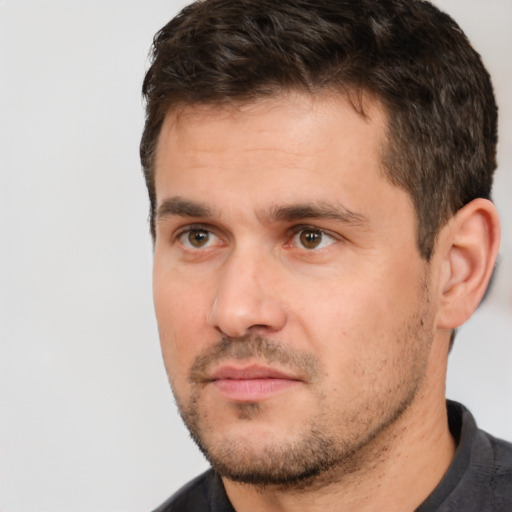 Joyful white adult male with short  brown hair and brown eyes