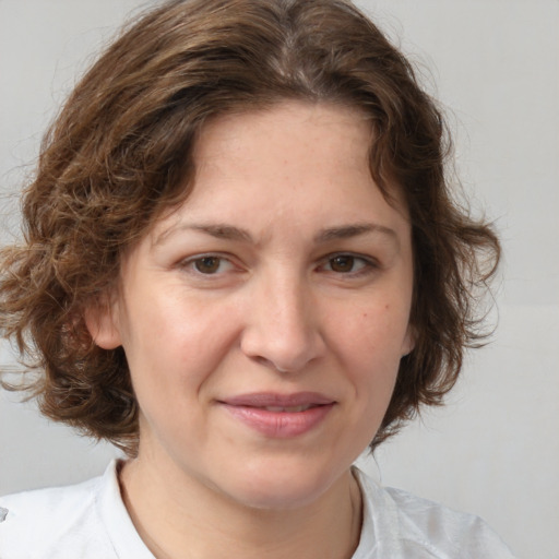 Joyful white adult female with medium  brown hair and brown eyes