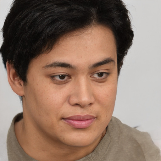 Joyful latino young-adult male with short  brown hair and brown eyes