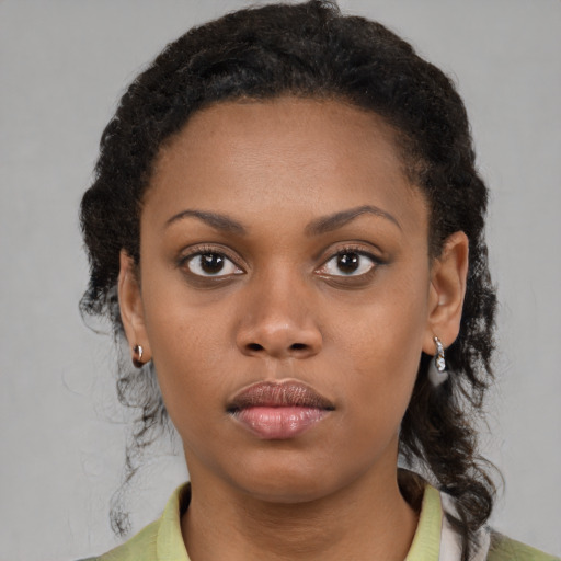 Neutral black young-adult female with medium  brown hair and brown eyes