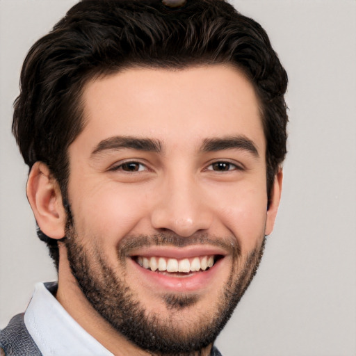 Joyful white young-adult male with short  black hair and brown eyes