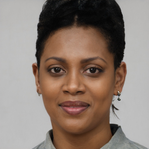 Joyful black young-adult female with short  black hair and brown eyes