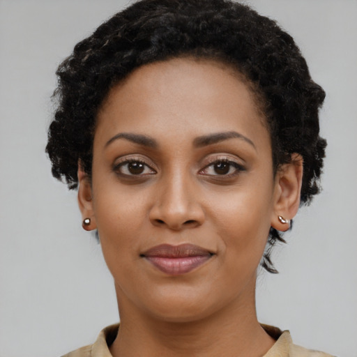 Joyful latino young-adult female with short  black hair and brown eyes