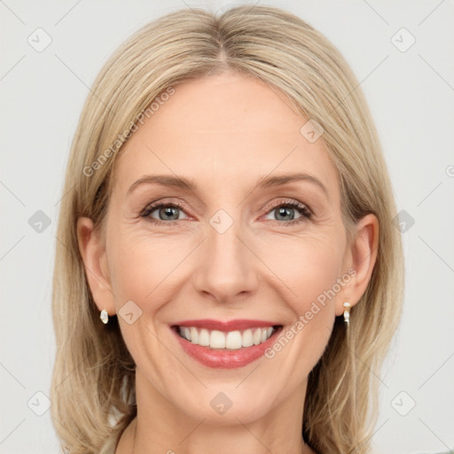 Joyful white adult female with medium  brown hair and grey eyes