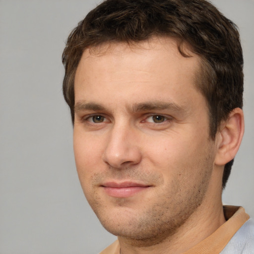 Joyful white young-adult male with short  brown hair and brown eyes