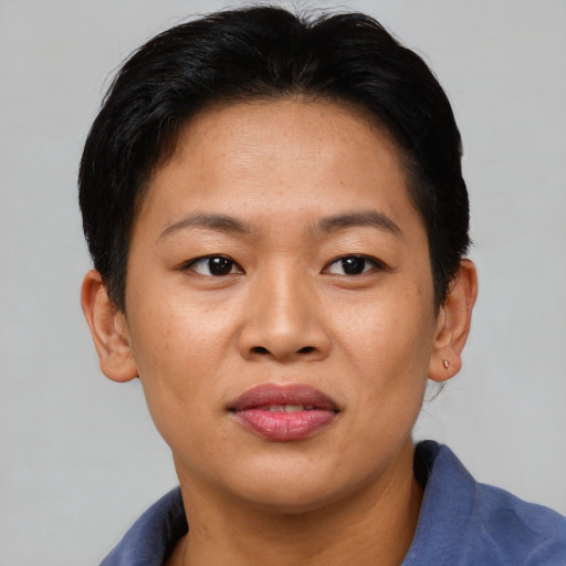 Joyful asian young-adult female with short  brown hair and brown eyes