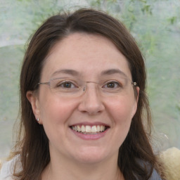 Joyful white adult female with medium  brown hair and brown eyes