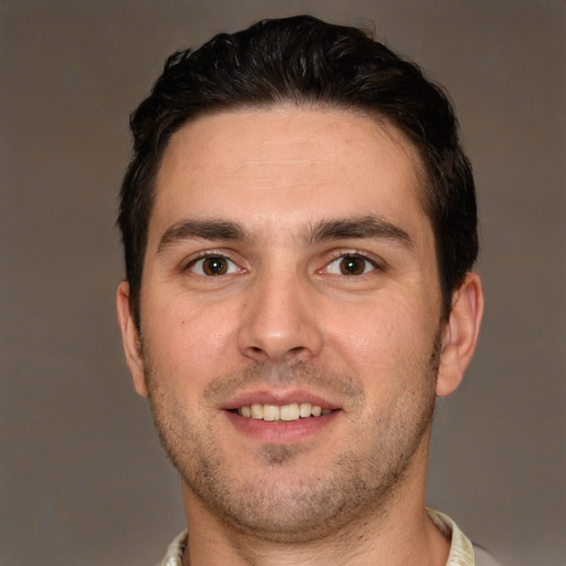 Joyful white young-adult male with short  brown hair and brown eyes