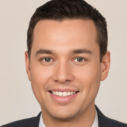 Joyful white young-adult male with short  brown hair and brown eyes