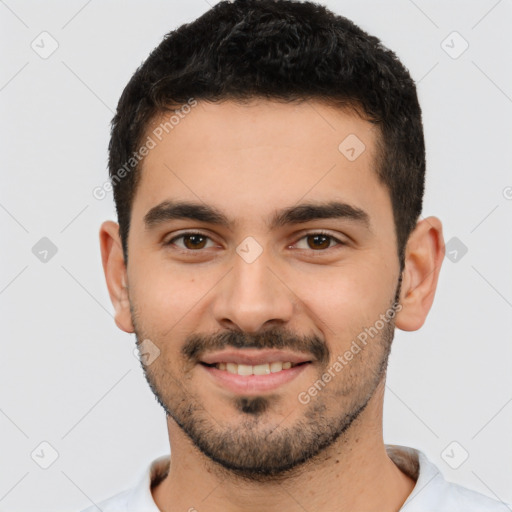 Joyful white young-adult male with short  black hair and brown eyes