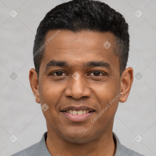 Joyful black young-adult male with short  black hair and brown eyes