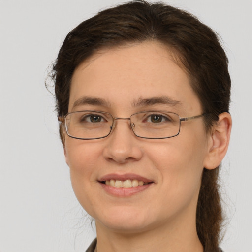 Joyful white adult female with medium  brown hair and brown eyes