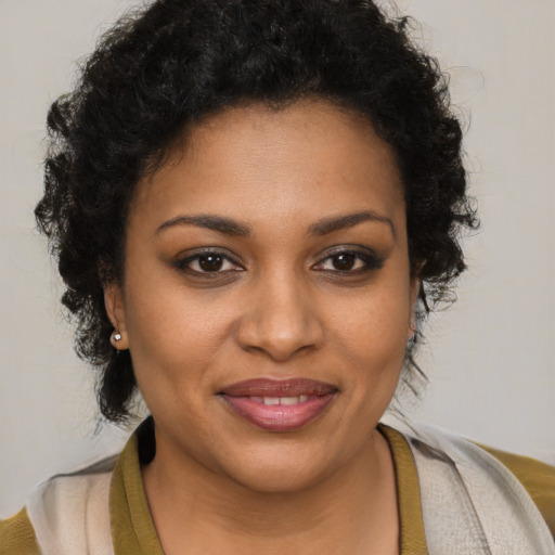 Joyful black young-adult female with medium  brown hair and brown eyes