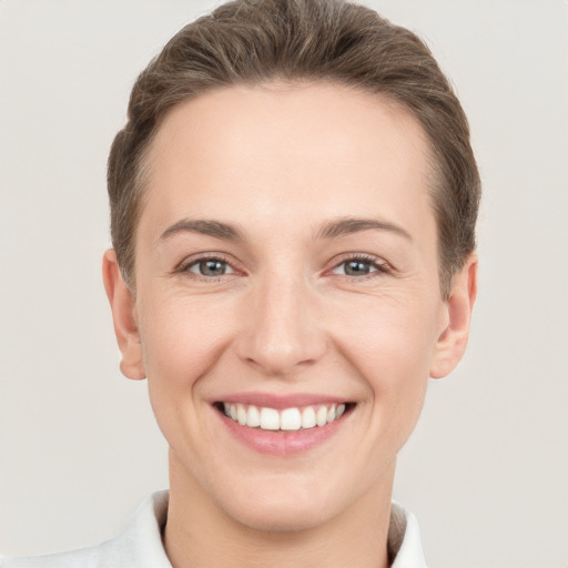 Joyful white young-adult female with short  brown hair and brown eyes