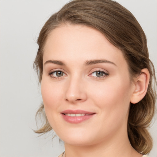 Joyful white young-adult female with medium  brown hair and blue eyes