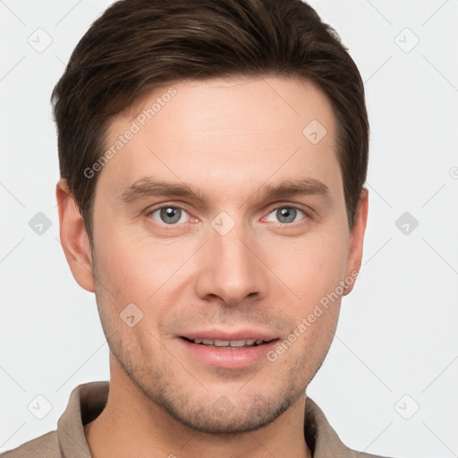 Joyful white young-adult male with short  brown hair and grey eyes