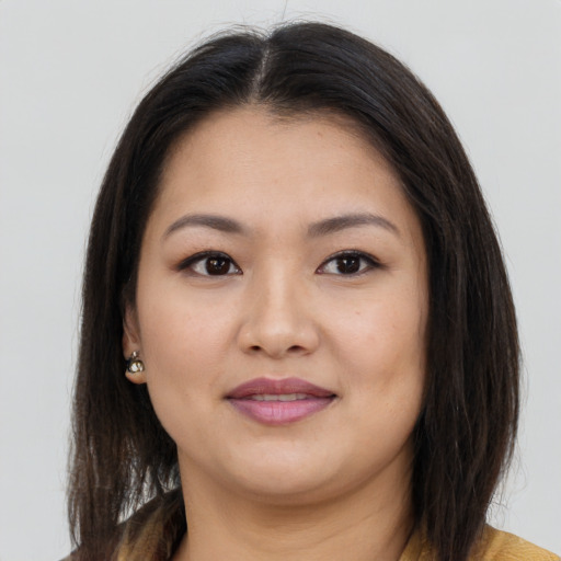 Joyful asian young-adult female with long  brown hair and brown eyes