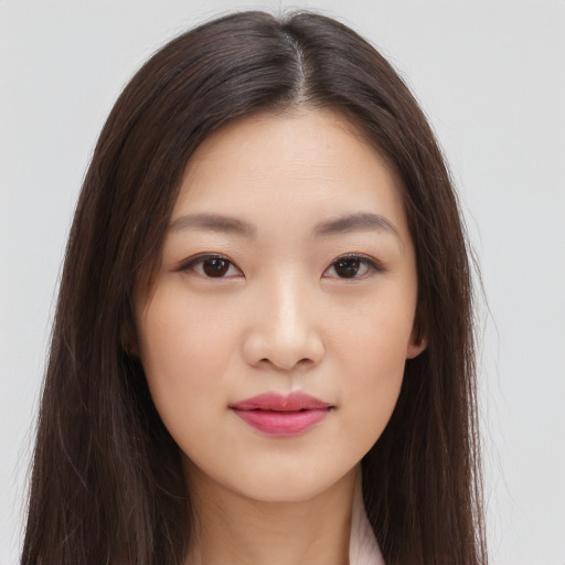 Joyful asian young-adult female with long  brown hair and brown eyes