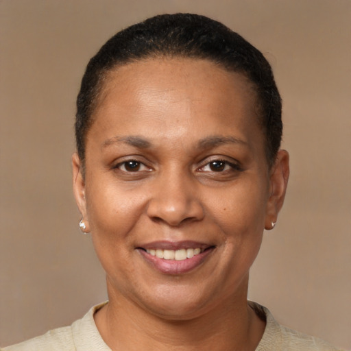 Joyful black adult female with short  brown hair and brown eyes