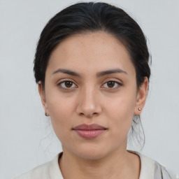 Joyful asian young-adult female with medium  brown hair and brown eyes