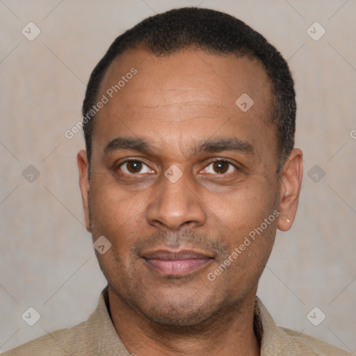 Joyful latino adult male with short  black hair and brown eyes