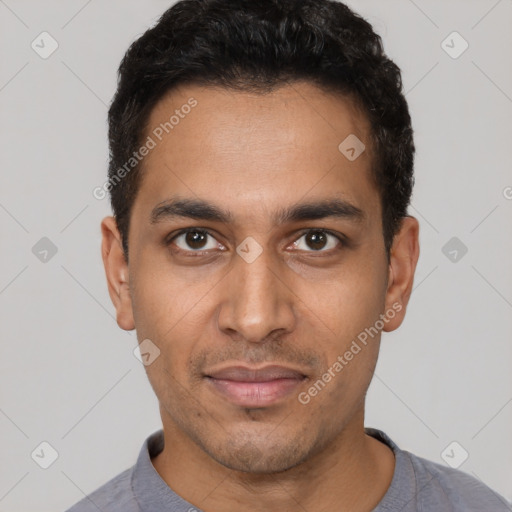 Joyful latino young-adult male with short  brown hair and brown eyes