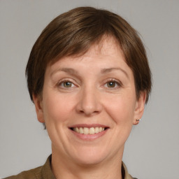 Joyful white adult female with medium  brown hair and grey eyes