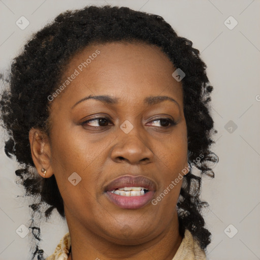 Joyful black adult female with medium  brown hair and brown eyes