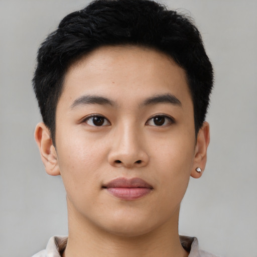 Joyful asian young-adult male with short  black hair and brown eyes