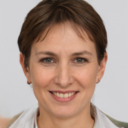 Joyful white adult female with short  brown hair and grey eyes