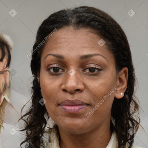 Joyful black adult female with medium  brown hair and brown eyes