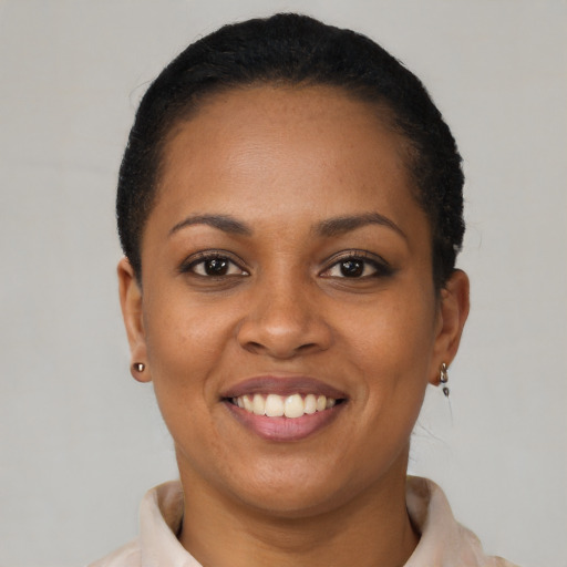 Joyful latino young-adult female with short  black hair and brown eyes