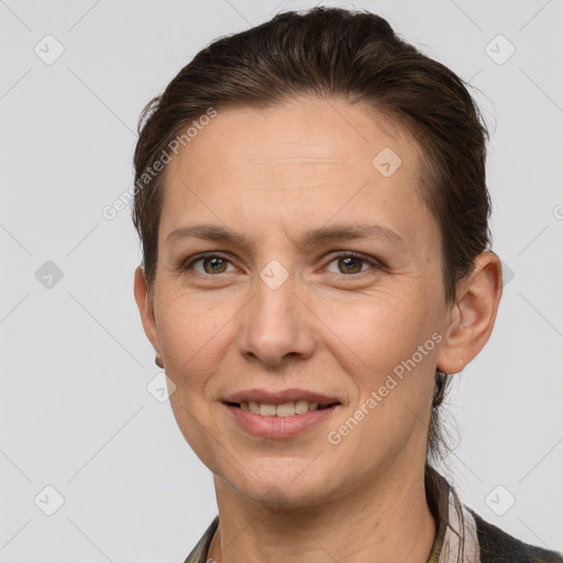 Joyful white adult female with short  brown hair and grey eyes