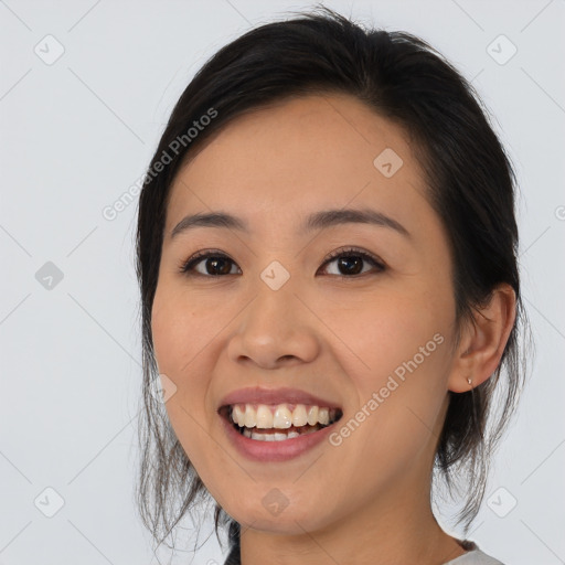 Joyful white young-adult female with medium  black hair and brown eyes