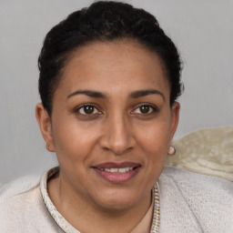 Joyful white adult female with short  brown hair and brown eyes