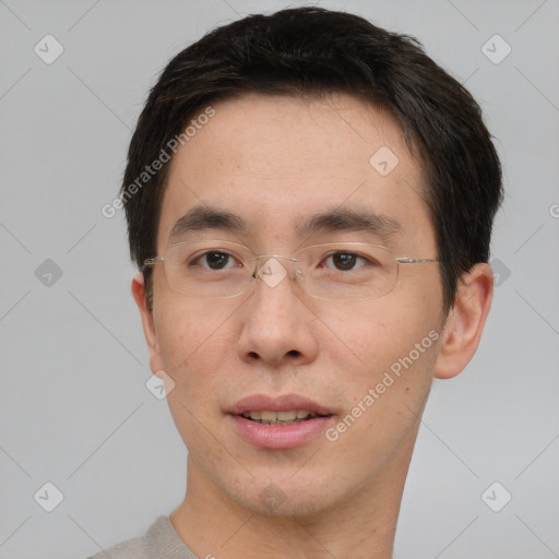 Joyful asian young-adult male with short  brown hair and brown eyes