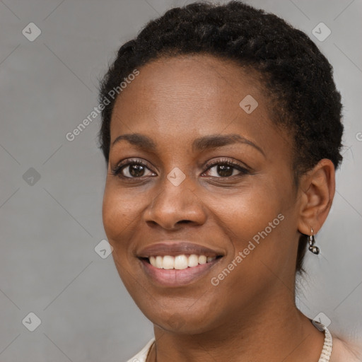 Joyful black young-adult female with short  brown hair and brown eyes