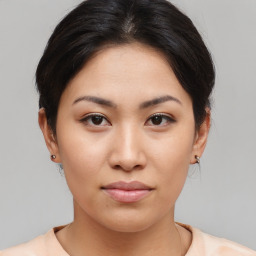 Joyful asian young-adult female with medium  brown hair and brown eyes