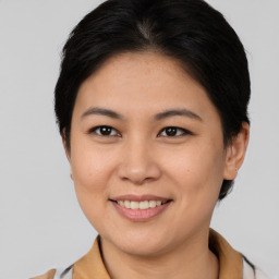 Joyful white young-adult female with medium  brown hair and brown eyes