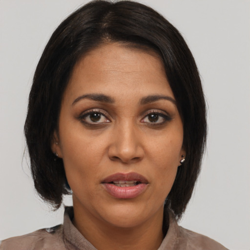 Joyful latino young-adult female with medium  brown hair and brown eyes