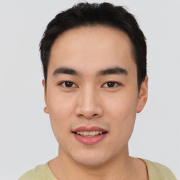 Joyful asian young-adult male with short  black hair and brown eyes