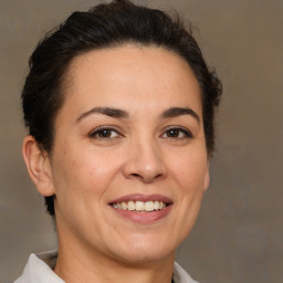 Joyful white adult female with medium  brown hair and brown eyes