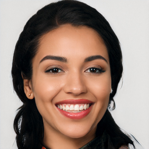 Joyful latino young-adult female with long  black hair and brown eyes