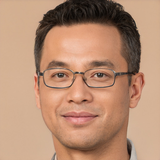 Joyful white adult male with short  brown hair and brown eyes