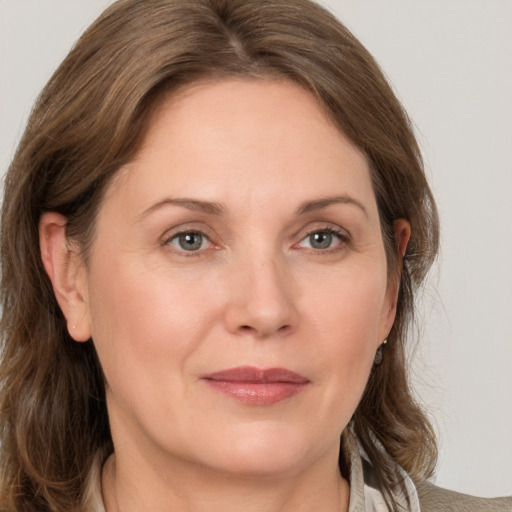 Joyful white adult female with medium  brown hair and grey eyes