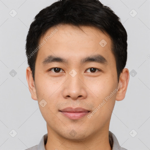 Joyful asian young-adult male with short  black hair and brown eyes