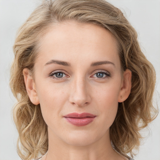 Joyful white young-adult female with long  brown hair and blue eyes