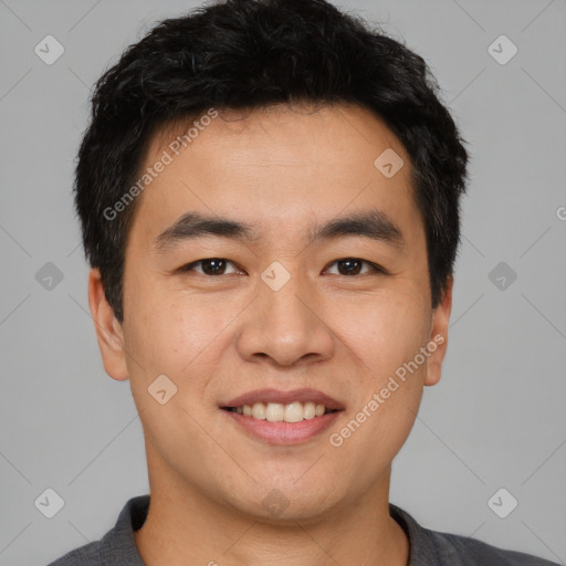 Joyful asian young-adult male with short  black hair and brown eyes